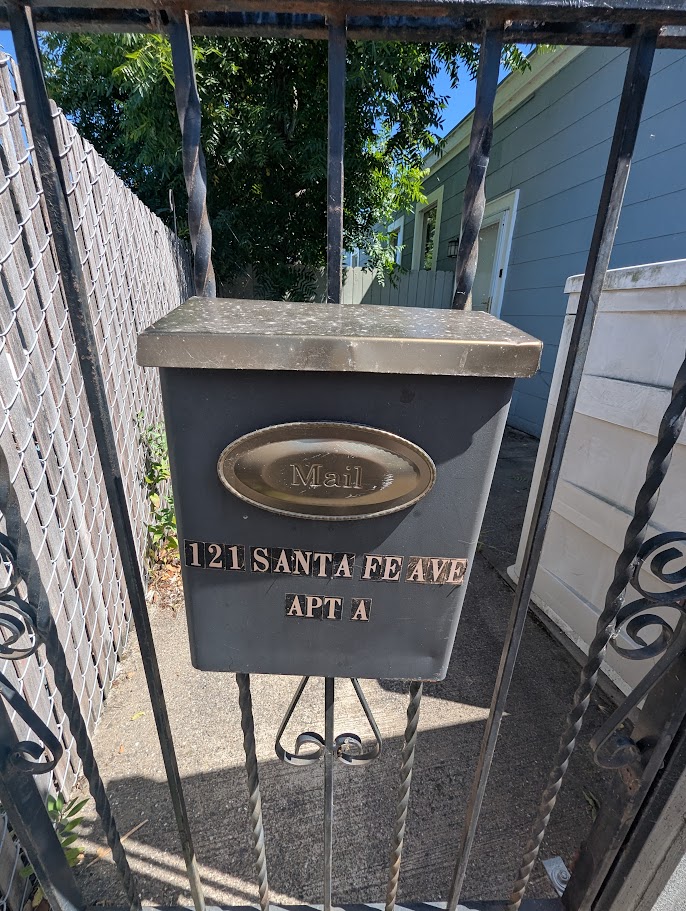 Mailbox for 121 Santa Fe Ave Apt A — the vacant rental unit at the start of the walkthrough